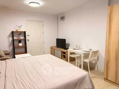 Cozy studio apartment with modern furnishings and compact dining area, perfect for urban living.