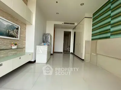 Spacious modern living room with sleek design and ample natural light, perfect for relaxation and entertainment.