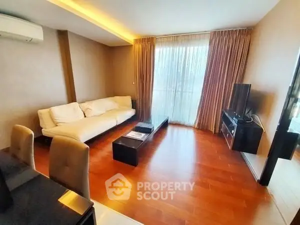 Spacious living room with modern decor and large windows for natural light.