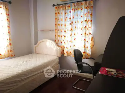 Cozy bedroom with natural light, featuring a comfortable bed and study desk, ideal for relaxation and productivity.