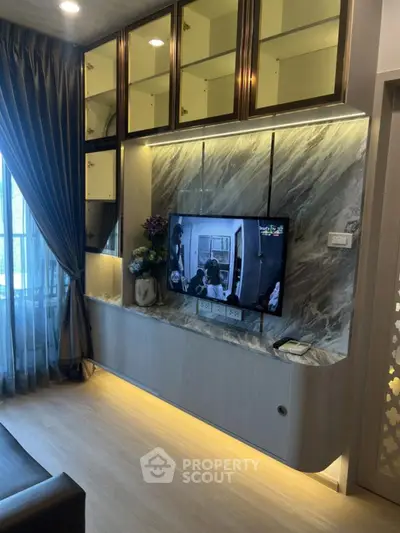 Modern living room with stylish TV wall unit and elegant lighting
