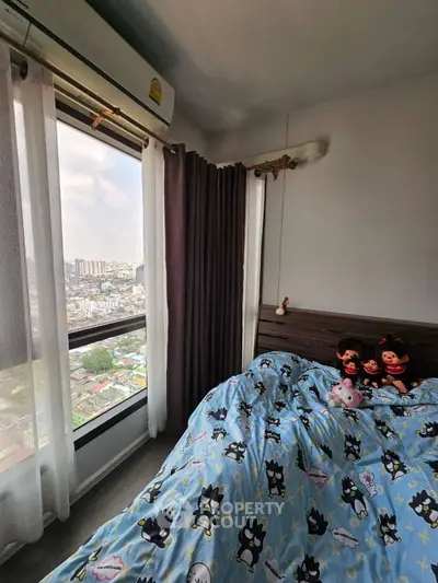 Cozy bedroom with city view, featuring large windows and charming decor, perfect for urban living.