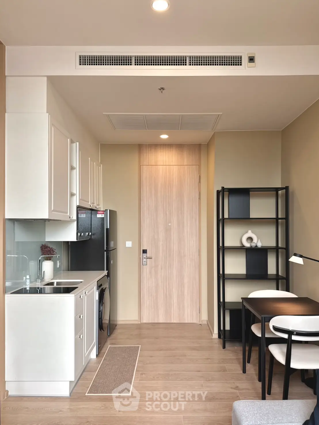 Modern studio apartment with sleek kitchen and cozy dining area