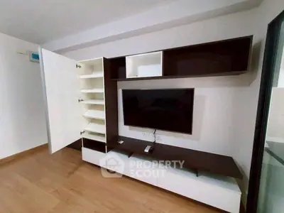 Modern living room with sleek TV unit and ample storage space
