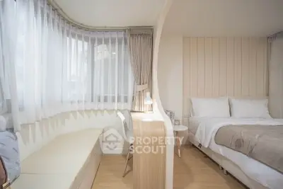 Modern bedroom with stylish partition and cozy seating area