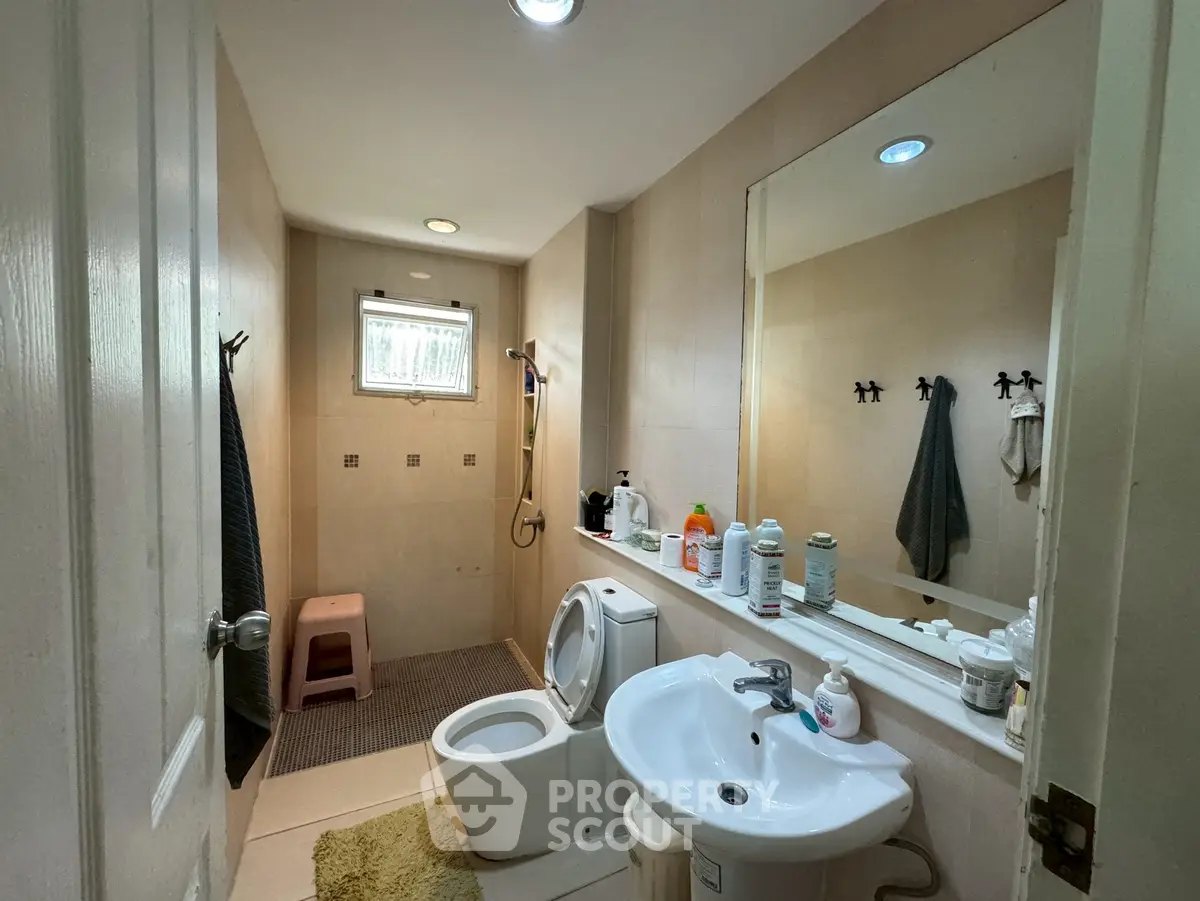 Spacious bathroom with modern fixtures and ample storage space.
