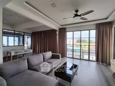 Spacious modern living room with large windows and stylish furniture