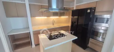 Modern kitchen with sleek appliances and island cooktop in stylish apartment