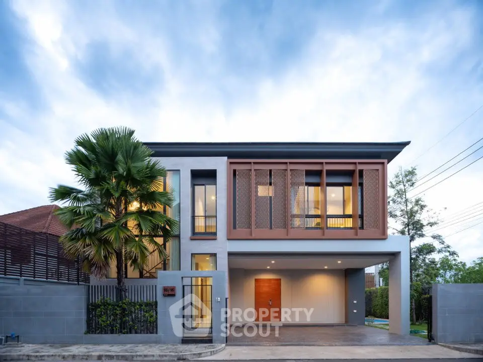 Modern two-story house with sleek design and lush landscaping