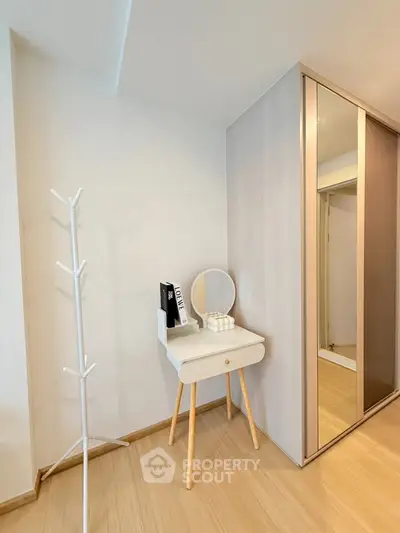Modern bedroom corner with stylish vanity and mirrored wardrobe