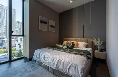 Modern bedroom with city view, stylish decor, and natural light.