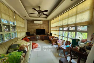 Spacious living room with large windows and cozy seating area