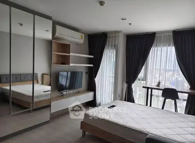 Modern bedroom with large windows, mirrored closet, and stylish decor in a high-rise apartment.