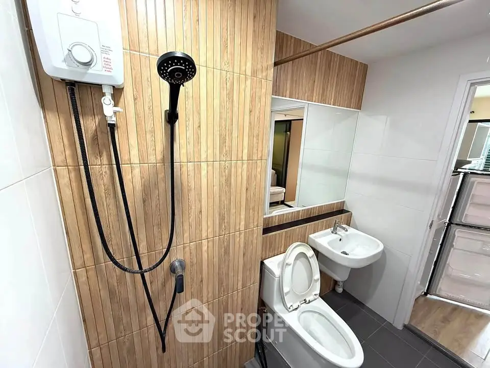 Modern bathroom with wood panel accents and sleek fixtures in a contemporary apartment.