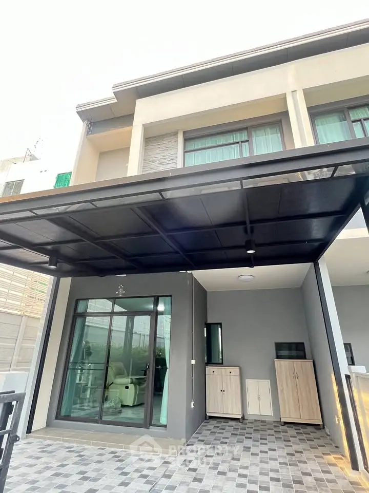 Modern townhouse exterior with covered parking and sleek design