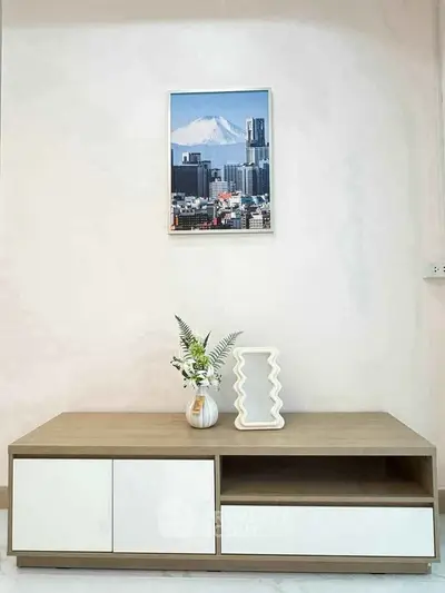 Modern minimalist living room with stylish wooden TV stand and decorative elements.