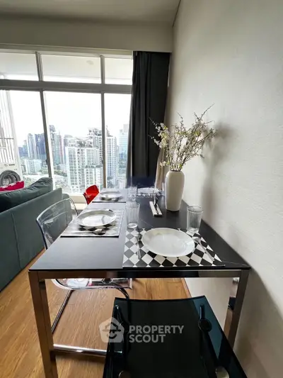 Modern dining area with city view, featuring sleek furniture and elegant decor in a high-rise apartment.