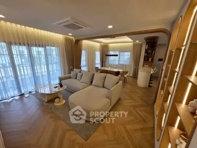 Spacious modern living room with elegant decor and large windows for natural light.