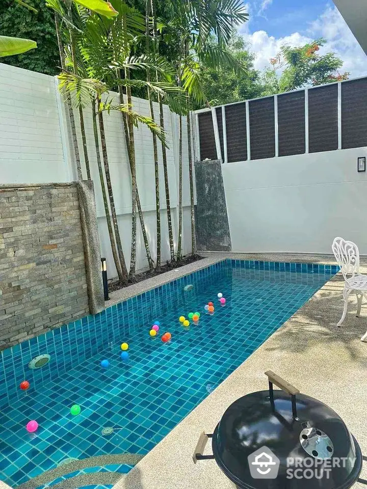 Charming outdoor pool area with vibrant tiles and lush greenery, perfect for relaxation and entertainment.