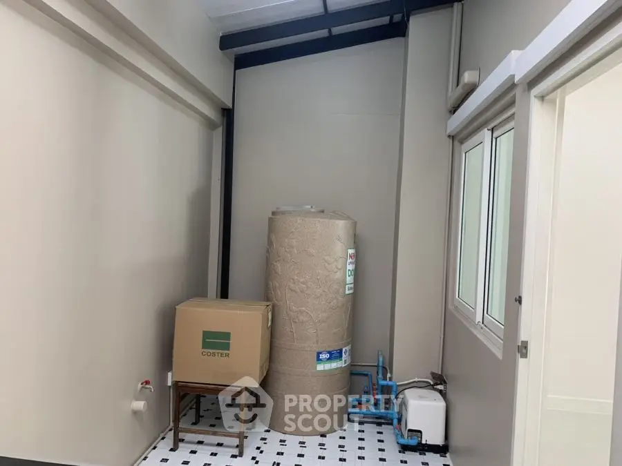 Utility room with water heater and storage box in modern home