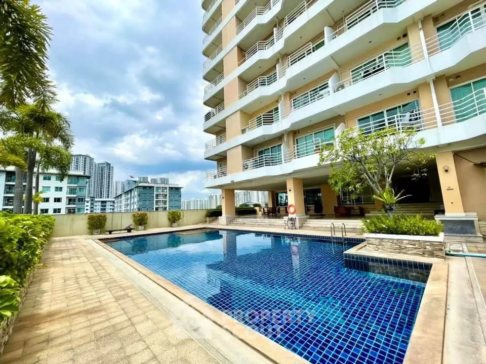 Luxurious condominium with a stunning outdoor pool and modern architecture, perfect for urban living.