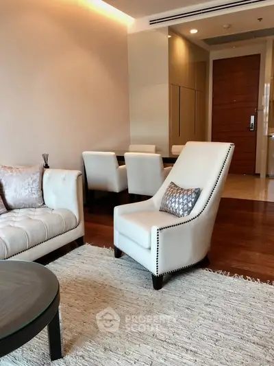 Elegant living room with plush seating and modern decor in a luxurious apartment.