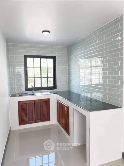 Modern kitchen with sleek countertops and stylish tiled backsplash