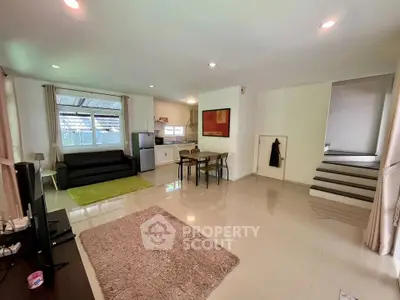 Spacious open-plan living room with modern kitchen and sleek design