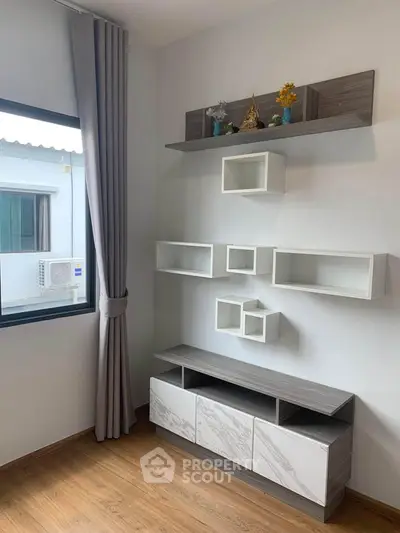 Modern living room with stylish shelving and wooden flooring