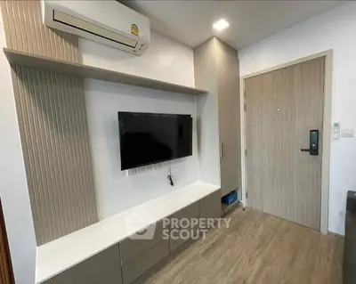 Modern living room with wall-mounted TV and sleek storage cabinets