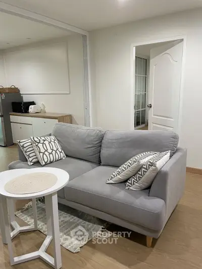 Cozy living room with modern gray sofa and stylish decor in a bright apartment.