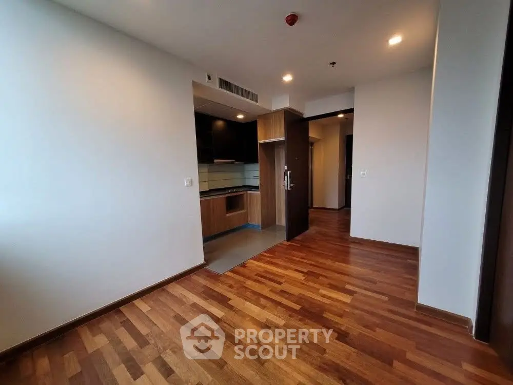 Spacious modern apartment with wooden flooring and open kitchen layout