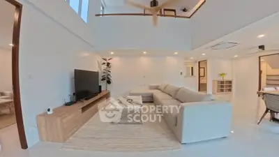Spacious modern living room with high ceilings and elegant decor