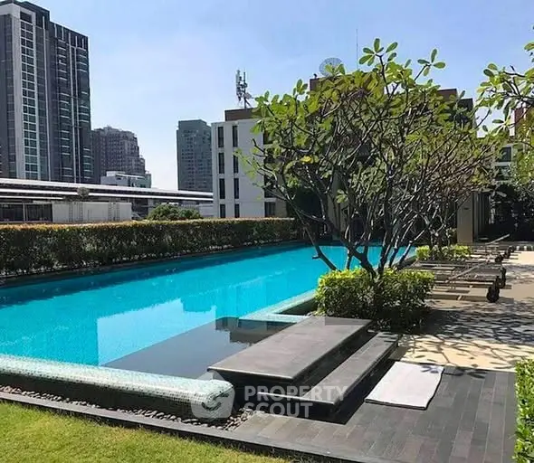Luxurious rooftop pool with stunning cityscape views and lush greenery.