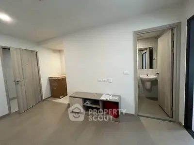 Modern apartment interior with bathroom and storage area, featuring sleek wooden doors and neutral tones.