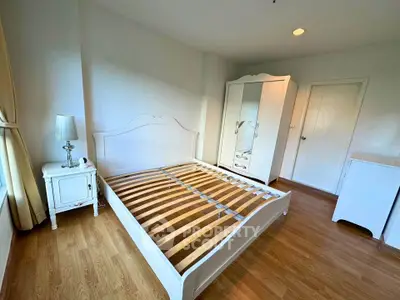 Spacious bedroom with elegant white furniture and natural light