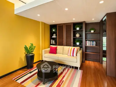 Stylish living room with vibrant yellow walls, cozy sofa, and modern decor in a contemporary home.