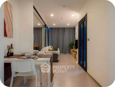 Modern open-plan living and dining area with stylish decor and cozy ambiance.