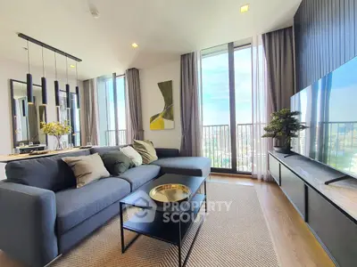 Modern living room with large windows and stylish decor in a high-rise apartment.