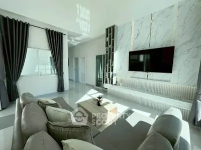 Luxurious modern living room with elegant marble wall and large TV, perfect for relaxation and entertainment.