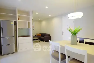 Modern open-plan living and dining area with sleek furniture and bright lighting.