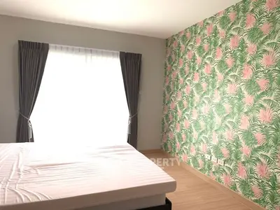 Bright bedroom with tropical wallpaper and large window
