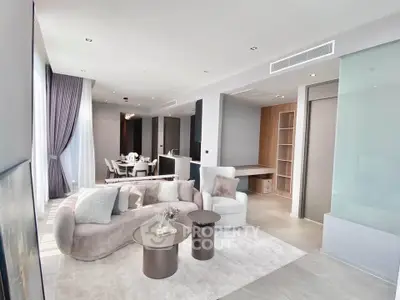 Luxurious modern living room with elegant furniture and open dining area, perfect for stylish urban living.