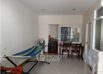 Cozy interior with hammock and dining area, perfect for relaxation and casual dining.