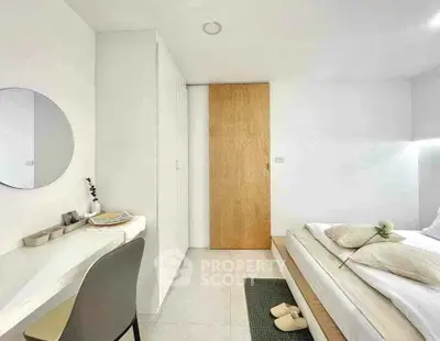 Modern minimalist bedroom with sleek design and natural light