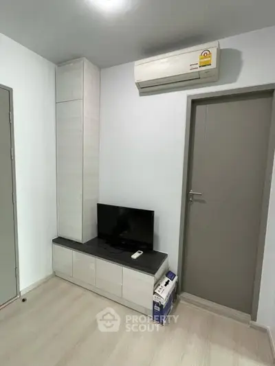 Modern minimalist living room with air conditioning and sleek TV setup