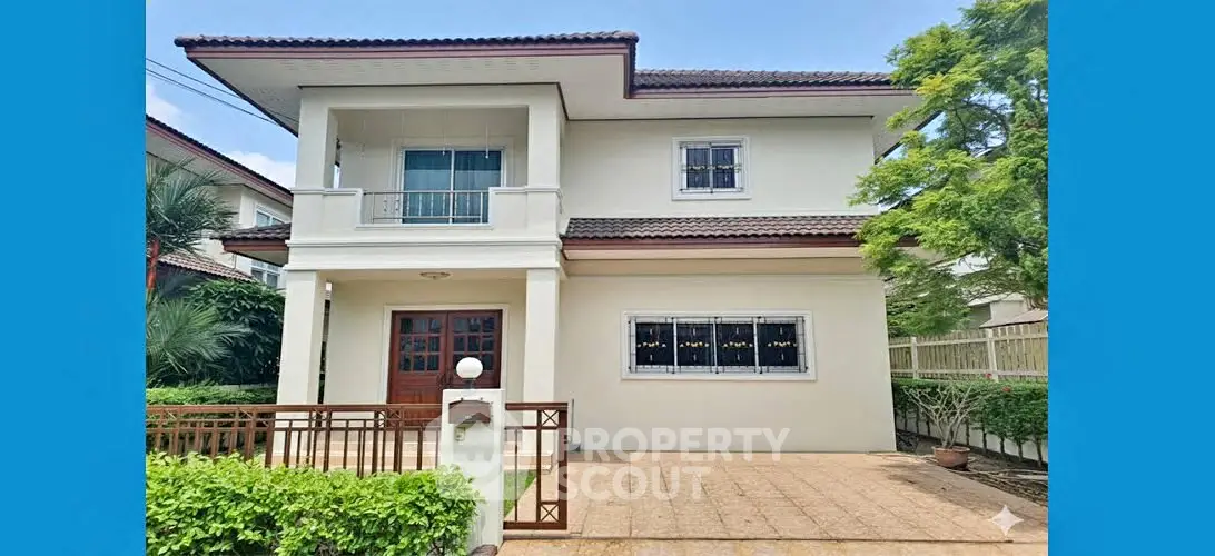 Charming two-story house with lush greenery and spacious driveway