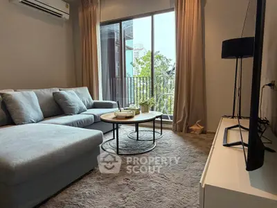 Modern living room with cozy sofa and balcony view in urban apartment