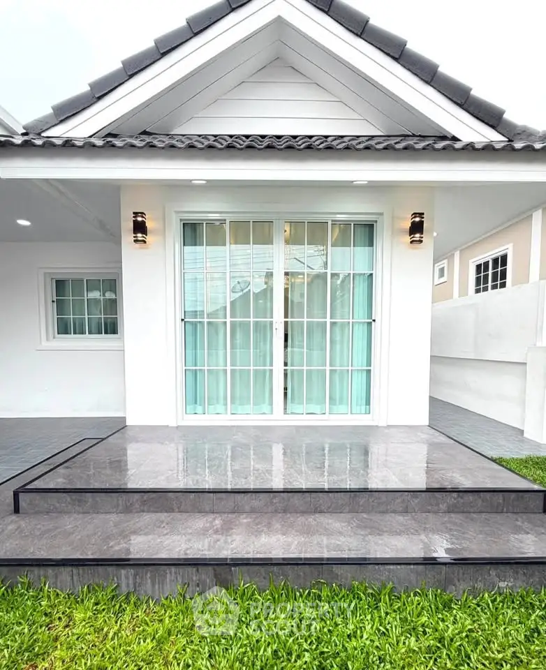 Charming modern house exterior with sleek glass doors and elegant steps, perfect for contemporary living.