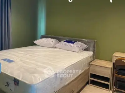 Cozy bedroom with green accent wall and modern furniture